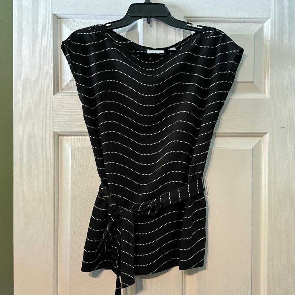 Black and white sleeveless top with belt to tie around the mid section